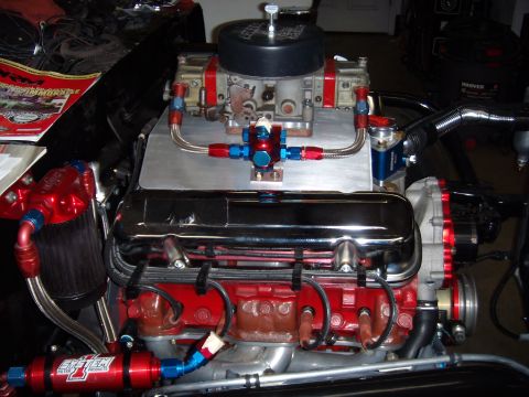 1984 Ford Bronco - Close-up of a V8 engine a Holley carburetor and custom fuel system components.