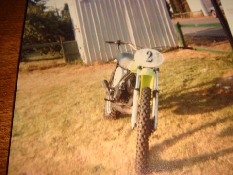 1996 Ford Bronco - A dirt bike with the number 2 displayed on its front plate sits in a grassy field.