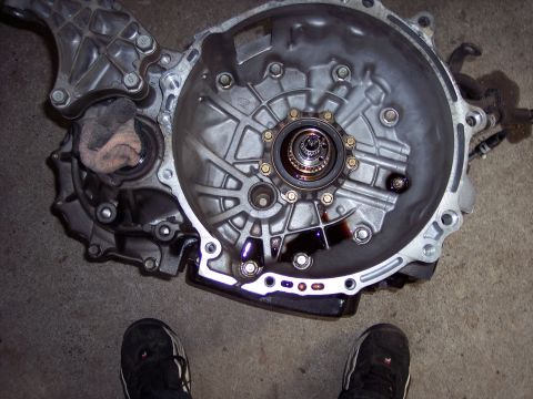 1995 Ford Probe - Close-up view of a vehicle transmission housing, showing internal gears and a rag.