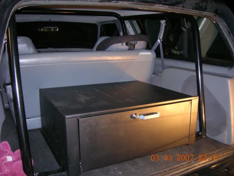 1996 Ford Bronco - Rear interior view of an SUV showing a custom-built storage box behind the back seats.