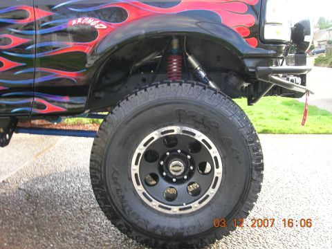 1996 Ford Bronco - Custom 1996 Ford Bronco showing flame graphics and modified suspension system.