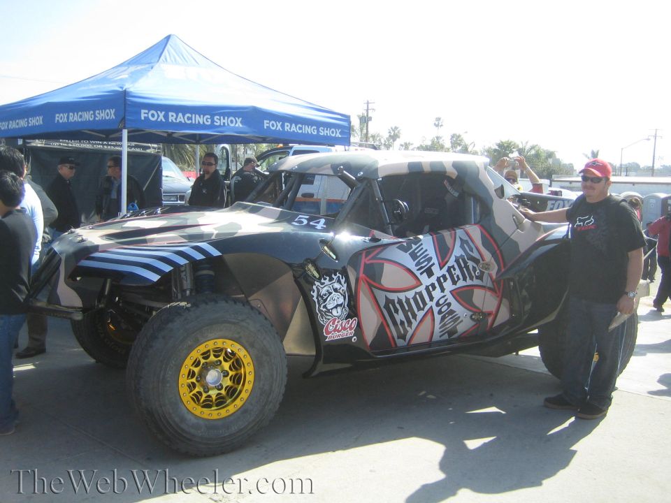 Black and silver number 54 off-road buggy with Choppers graphics and a man