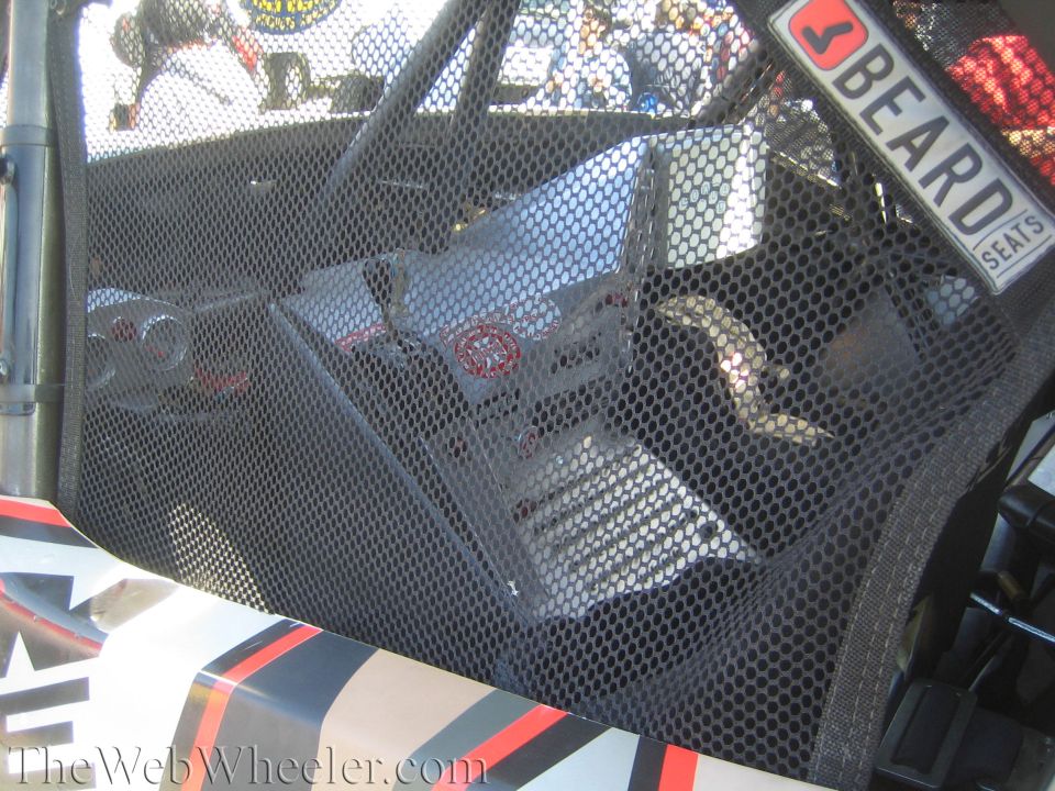 Close-up of mesh window net and Beard Seats sticker on a race vehicle