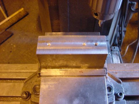 1994 Ford Bronco - A metal vise secures a component, likely for machining or repair, in a workshop setting.