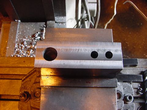 1994 Ford Bronco - Metal part being machined on a lathe, with shavings accumulating.