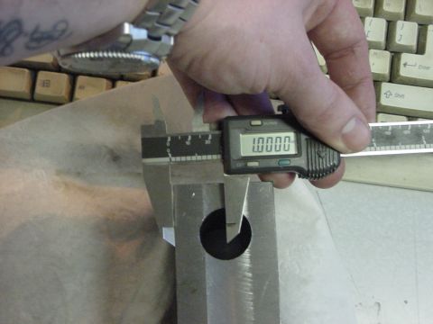 1994 Ford Bronco - A digital caliper is used to measure a metal component, with a keyboard visible in the background.