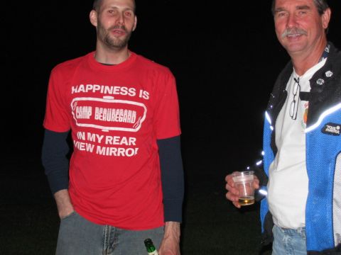 1985 Ford LTD Crown Victoria - Two men stand outdoors at night, one wearing a t-shirt with text about Camp Beauregard.