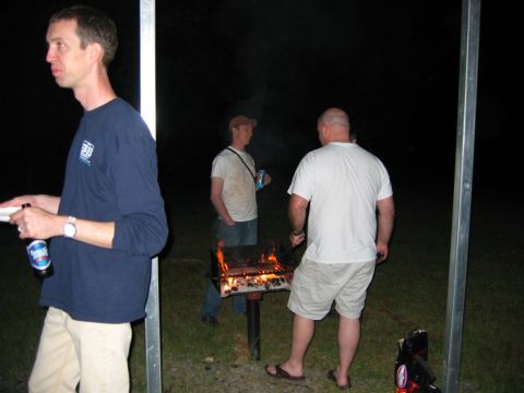 1985 Ford LTD Crown Victoria - Men gather around a fire pit for a nighttime barbecue.