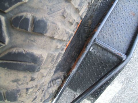 1995 Ford Bronco - Detail of an off-road tire and a metal step, likely from a truck or SUV.