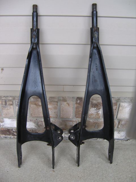 1989 Ford Bronco - Two black control arms are shown, likely for a vehicle's suspension system.