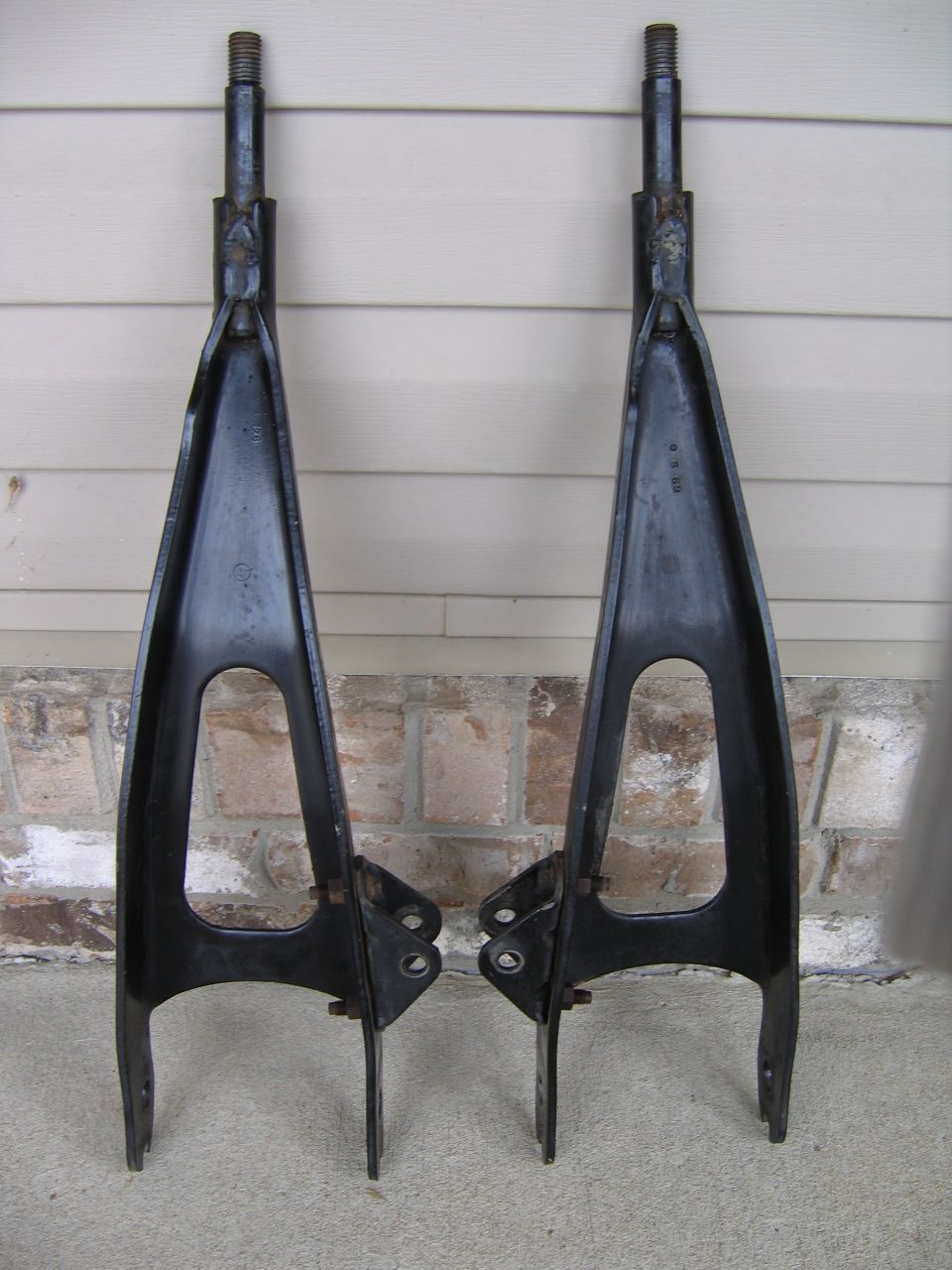 Pair of black control arms with threaded ends and mounting brackets