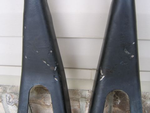 1989 Ford Bronco - Pair of black metal suspension control arms, likely from a truck or SUV.