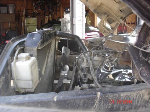 1979 Ford Bronco - Close-up view of a vehicle's engine bay, including the radiator and fan assembly.