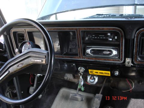 1979 Ford Bronco - Interior view of a 1979 Ford Bronco, the dashboard, steering wheel, and aftermarket accessories.