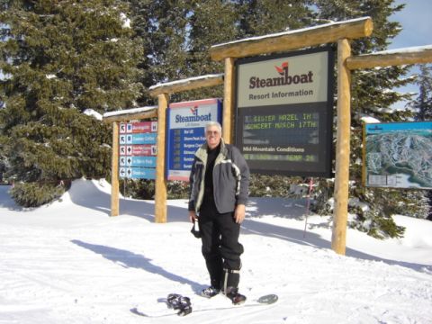 1992 Ford Bronco - A man poses for a photo in the snow at Steamboat Resort, with various informational signs visible.