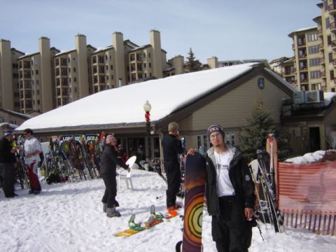 1992 Ford Bronco - A group of people are gathered outside a ski lodge with their snowboards and skis, ready for a day on the slopes.