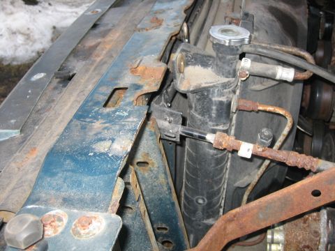 1994 Ford Bronco - Close-up of a vehicle's radiator and associated plumbing, showing signs of rust.