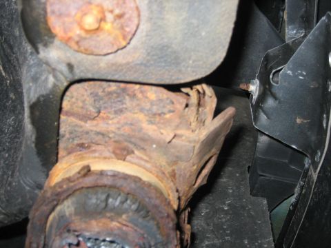 1994 Ford Bronco - Close-up view of corroded undercarriage components, showing significant rust damage.