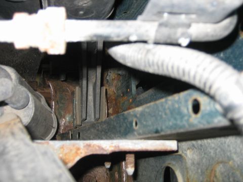 1994 Ford Bronco - Detail shot of corroded metal components and hoses, likely from the undercarriage of a vehicle.