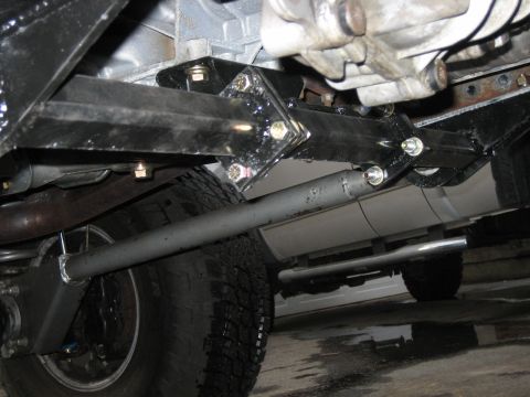 1994 Ford Bronco - Custom suspension brackets and shock absorber visible on the underside of a vehicle.