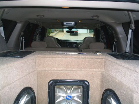 2000 Ford Excursion - Custom subwoofer enclosure installed in the rear cargo area of a 2000 Ford Excursion.