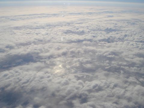 1996 Ford Bronco - View from above the clouds, showing patches of land below.
