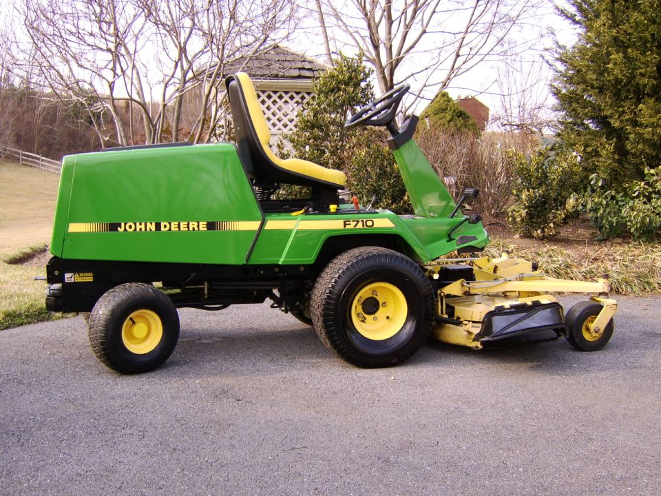 John Deere F710 front-mount riding mower parked on an asphalt driveway