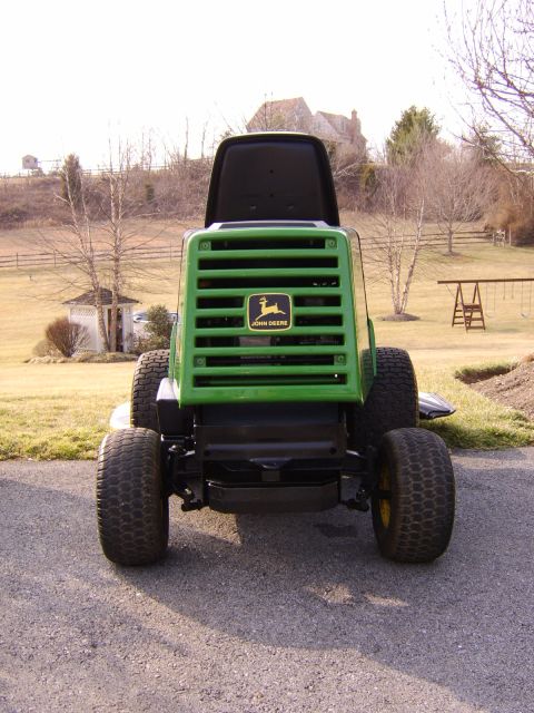 1996 Mercury Grand Marquis - John Deere lawn tractor parked outdoors on a paved surface.