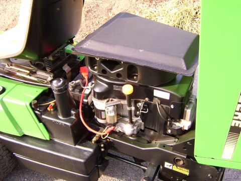 1996 Mercury Grand Marquis - Close-up view of a green lawn mower's engine compartment.