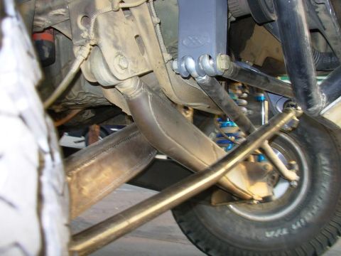 1984 Ford Bronco - This image shows the complex suspension system of a modified off-road vehicle, focusing on the steering and shock absorbers.