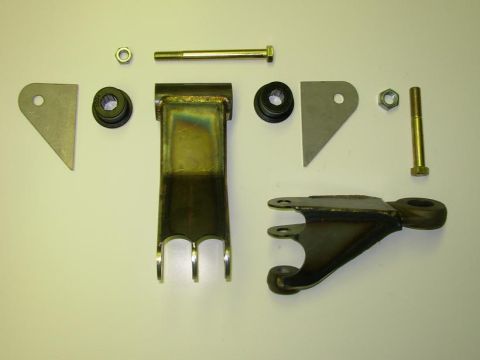 1984 Ford Bronco - Various steering linkage components are laid out, including brackets, bushings, and fasteners.