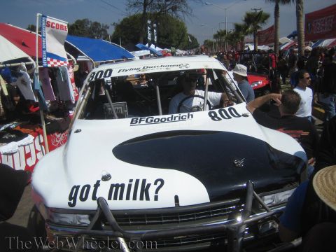 1990 Ford Bronco - white off-road race truck numbered 800 with got milk? lettering on its hood is parked in a packed crowd at an outdoor expo.