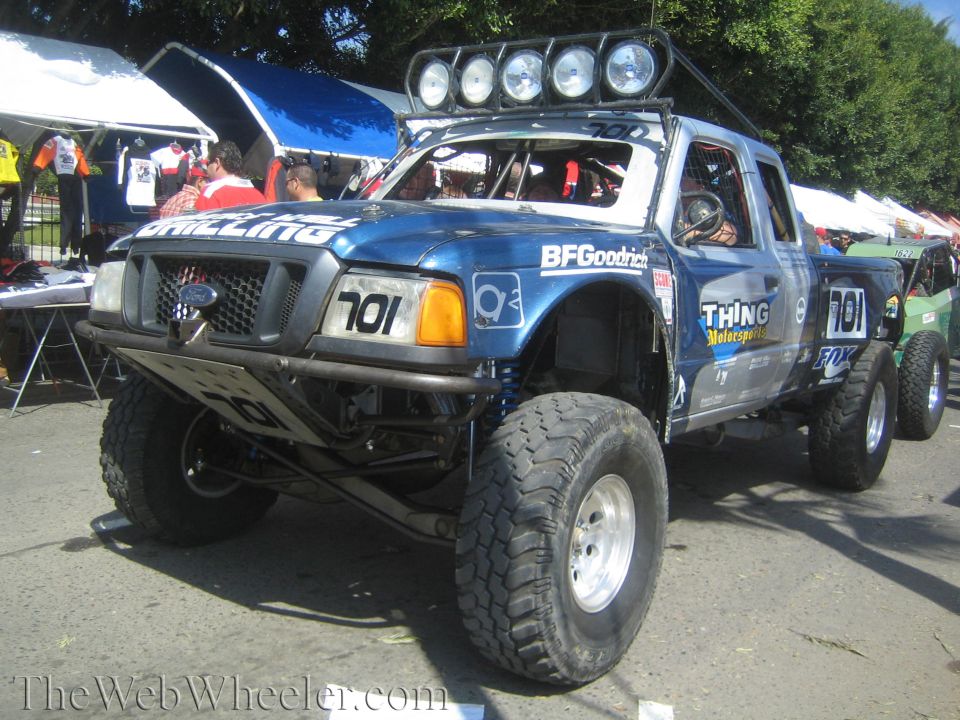 Blue Ford Ranger prerunner race truck No. 701 with roof light bar at event