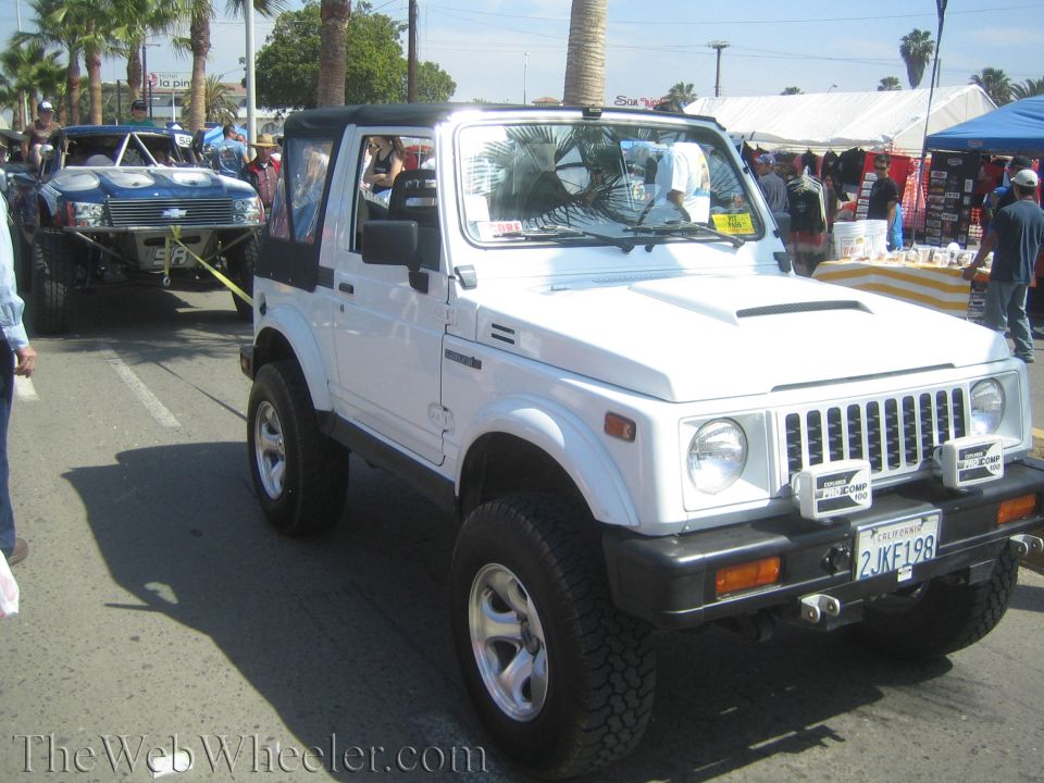 White Suzuki Samurai 4x4 with lift kit and California plate at event