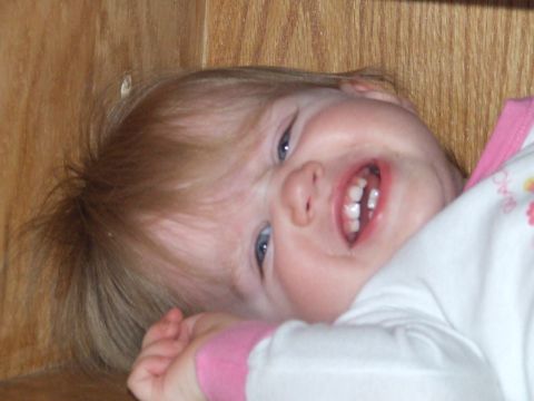 1990 Ford Bronco - A baby with a wide smile and blue eyes is captured in this close-up photograph.