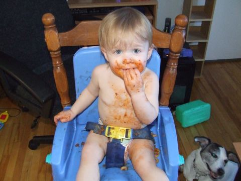 1990 Ford Bronco - Messy toddler eating in a high chair with a dog nearby.