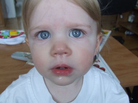 1990 Ford Bronco - Toddler's face with bright blue eyes and a slightly wet nose.