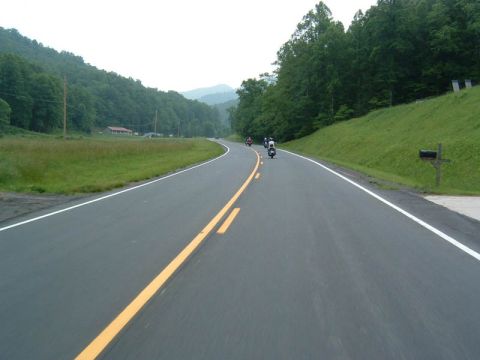 1985 Ford LTD Crown Victoria - Motorcycles traveling on a scenic route through the countryside.