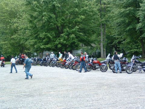 1985 Ford LTD Crown Victoria - Motorcycle enthusiasts gather for an event, with many bikes parked in rows.
