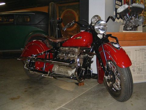1985 Ford LTD Crown Victoria - A vintage red motorcycle is displayed indoors, with a document visible in the background.