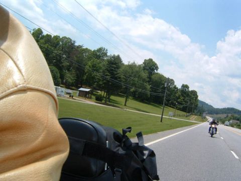 1985 Ford LTD Crown Victoria - A motorcycle rider's perspective on a highway, with another motorcycle visible in the distance.