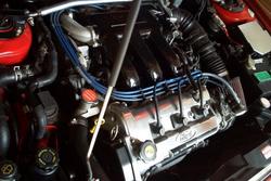 1997 Ford Probe - Close-up view of a car's engine compartment, showing various components and the Ford logo.