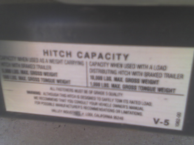 View of the receiver's weight limit label.  5000lbs off a standard hitch and 10000lbs with a weight distributing hitch.  Of course the truck's GCWR is only 11500 because of the small-block engine and four-wheel-drive, so if the truck weighs 5600 like I think it does, then it could only tow 5900lbs.