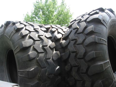 1974 Ford F-100 - Close-up view of aggressive tread patterns on large off-road tires, suggesting off-road capability.