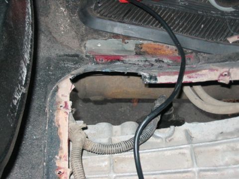 1991 Ford Bronco - Close-up view of the undercarriage of a vehicle, showing signs of rust and exposed components.