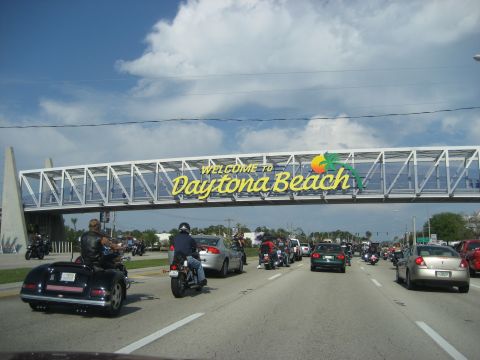 1986 Ford Bronco - Traffic moves under the welcome sign for Daytona Beach on a sunny day.