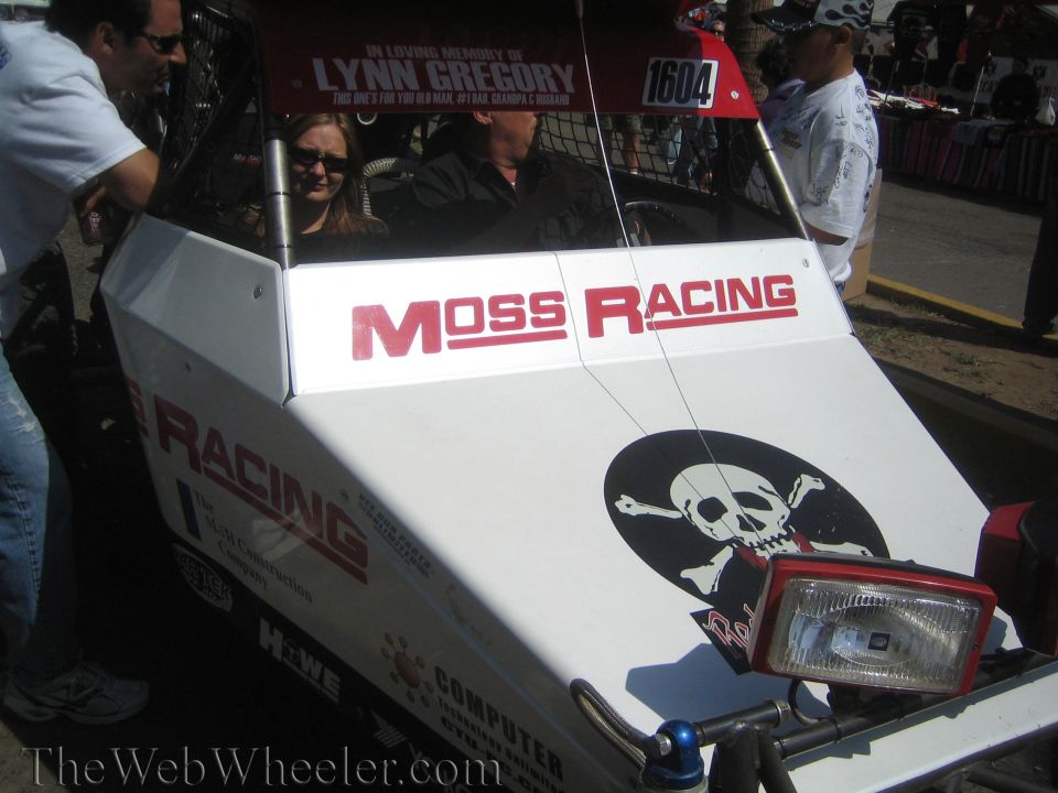 Close-up of white off-road buggy with 'Moss Racing' decal and skull-and-crossbones graphic
