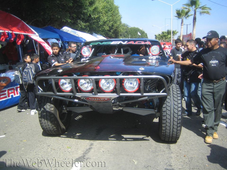 Black Ensenada off-road trophy truck with four driving lights and crowd