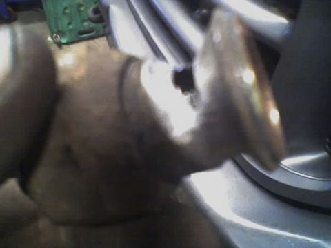 1992 Ford Bronco - Detail of a vehicle's exhaust system component, likely a pipe or muffler, in a workshop setting.