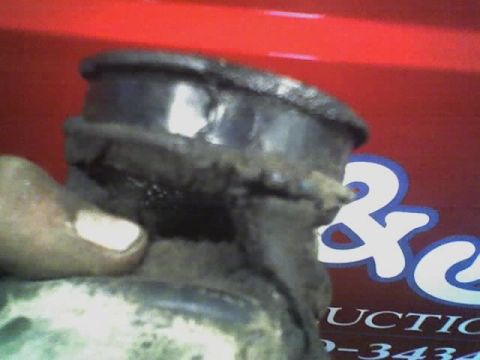 1992 Ford Bronco - A close-up shows a deteriorated rubber bushing, likely a suspension component, against a red backdrop with a large '2' graphic.